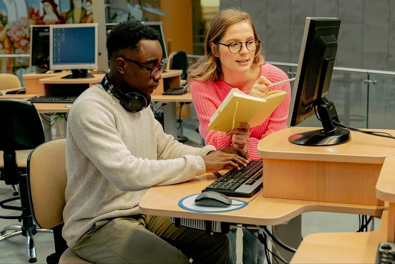 Students learning cybersecurity and IT at PC AGE Career Institute