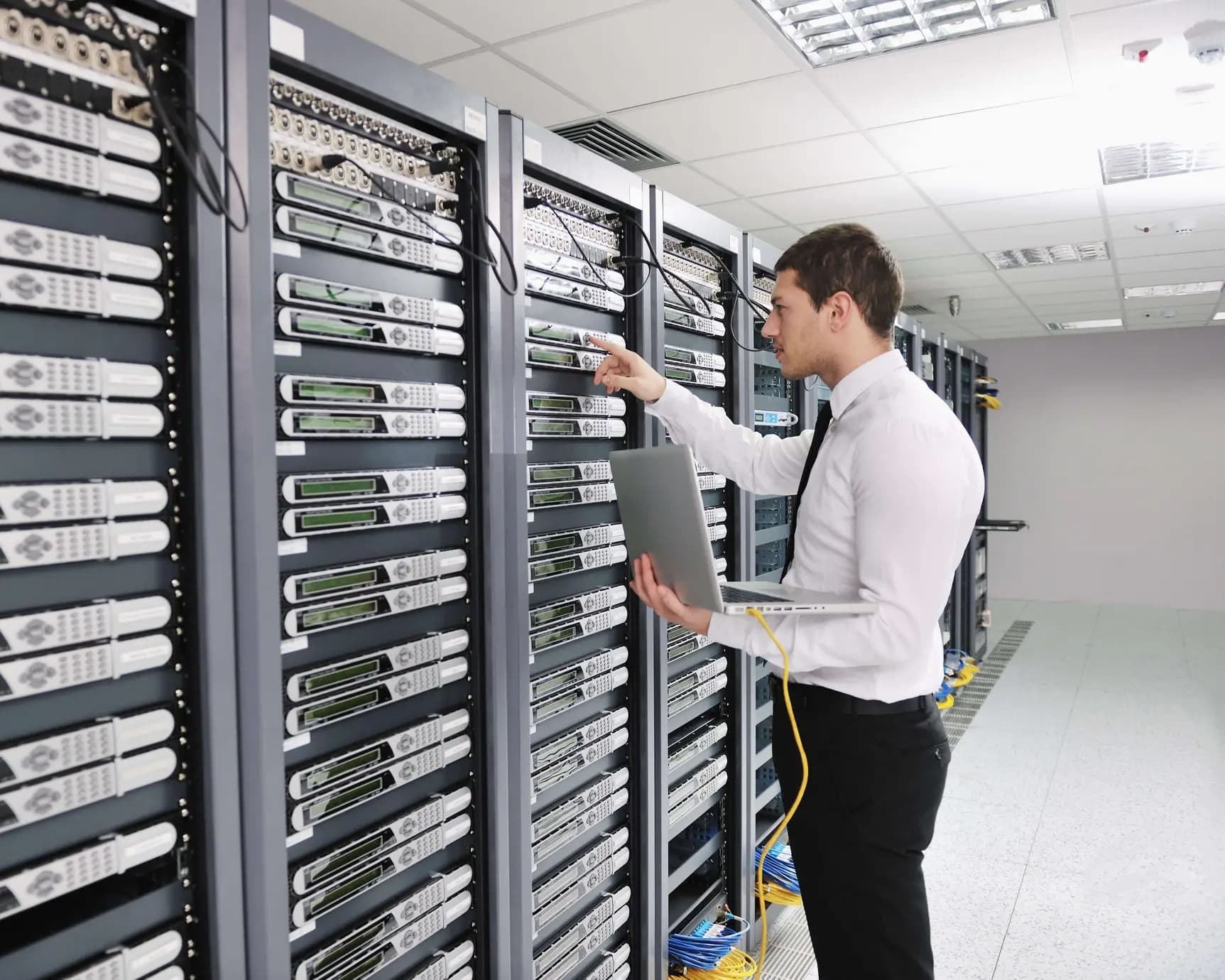 A student with a computer in a server room